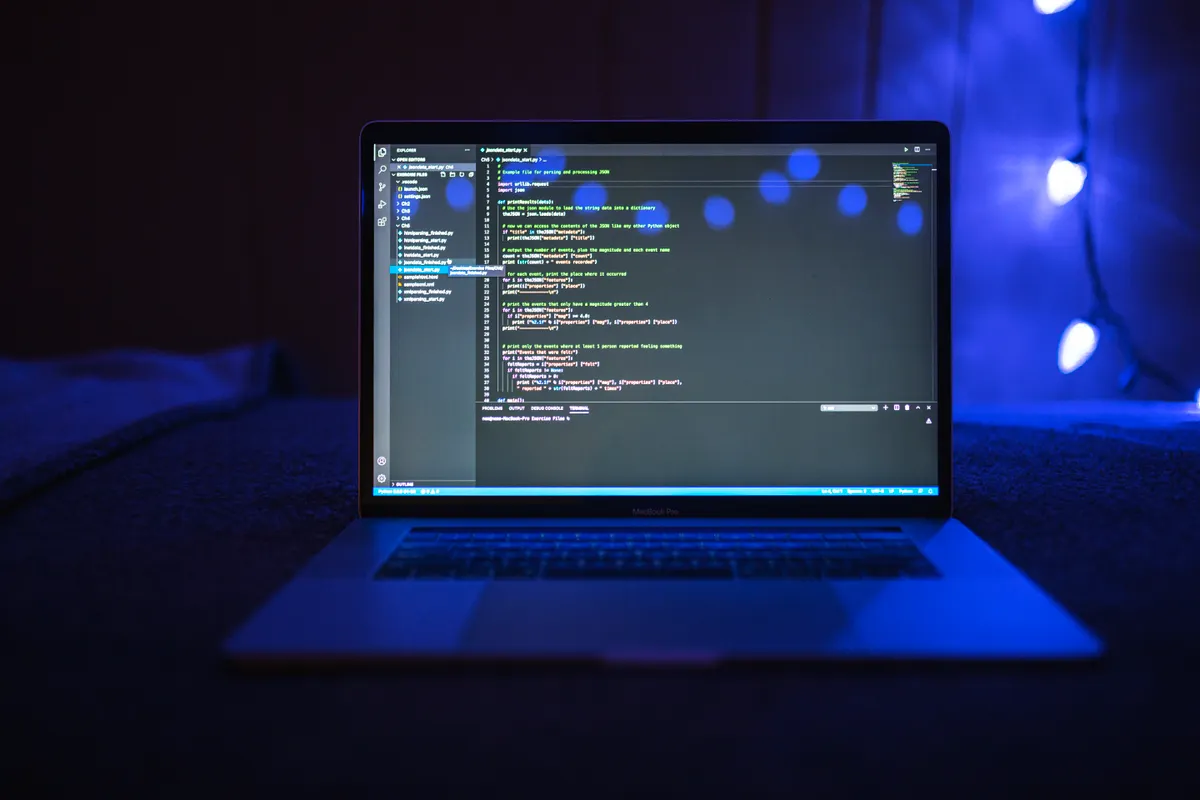 Laptop screen showing code in a dark room, for preparing the Android system design round
