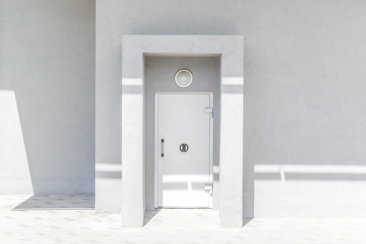 A single white door in a white wall, illustrating a decision with incomplete information interview answer about reversible choices