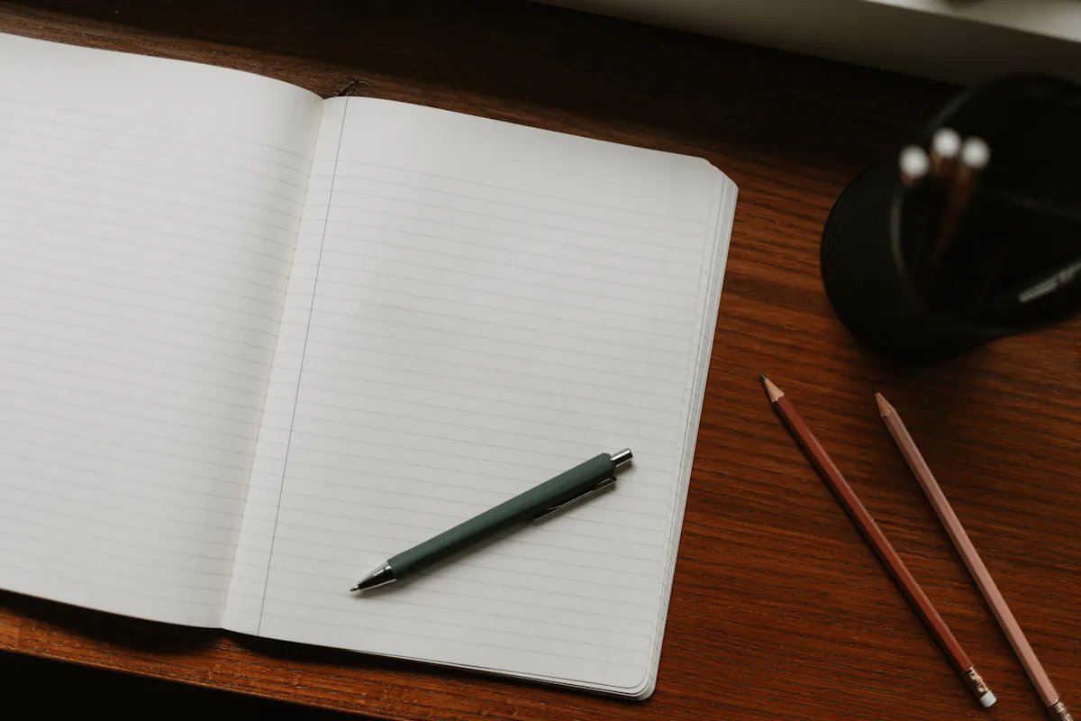 Open blank notebook and pen on a desk, for preparing a STAR answer before a behavioral interview