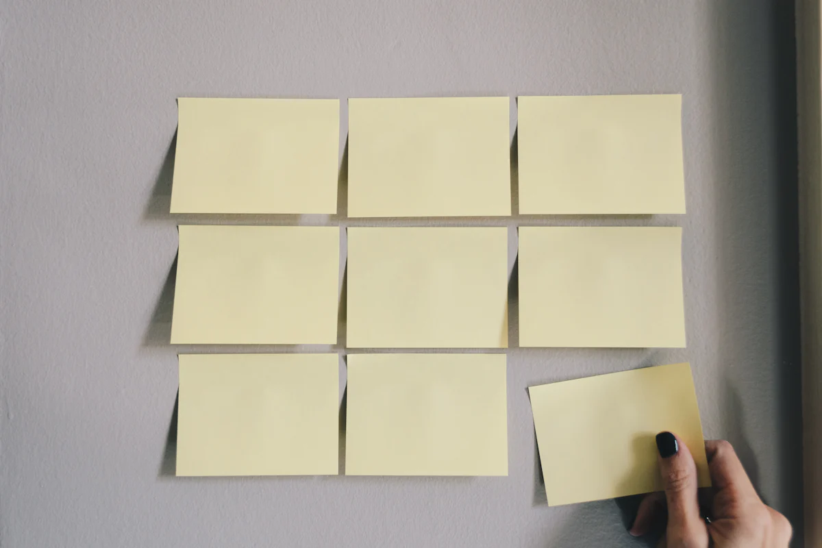 Blank sticky notes in a grid, like interviewer notes lined up after an Amazon bar raiser interview