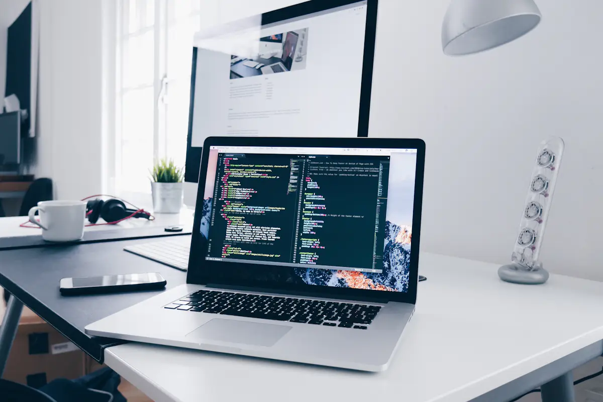 Laptop with a code editor on a desk, ready for a CodeSignal General Coding Assessment